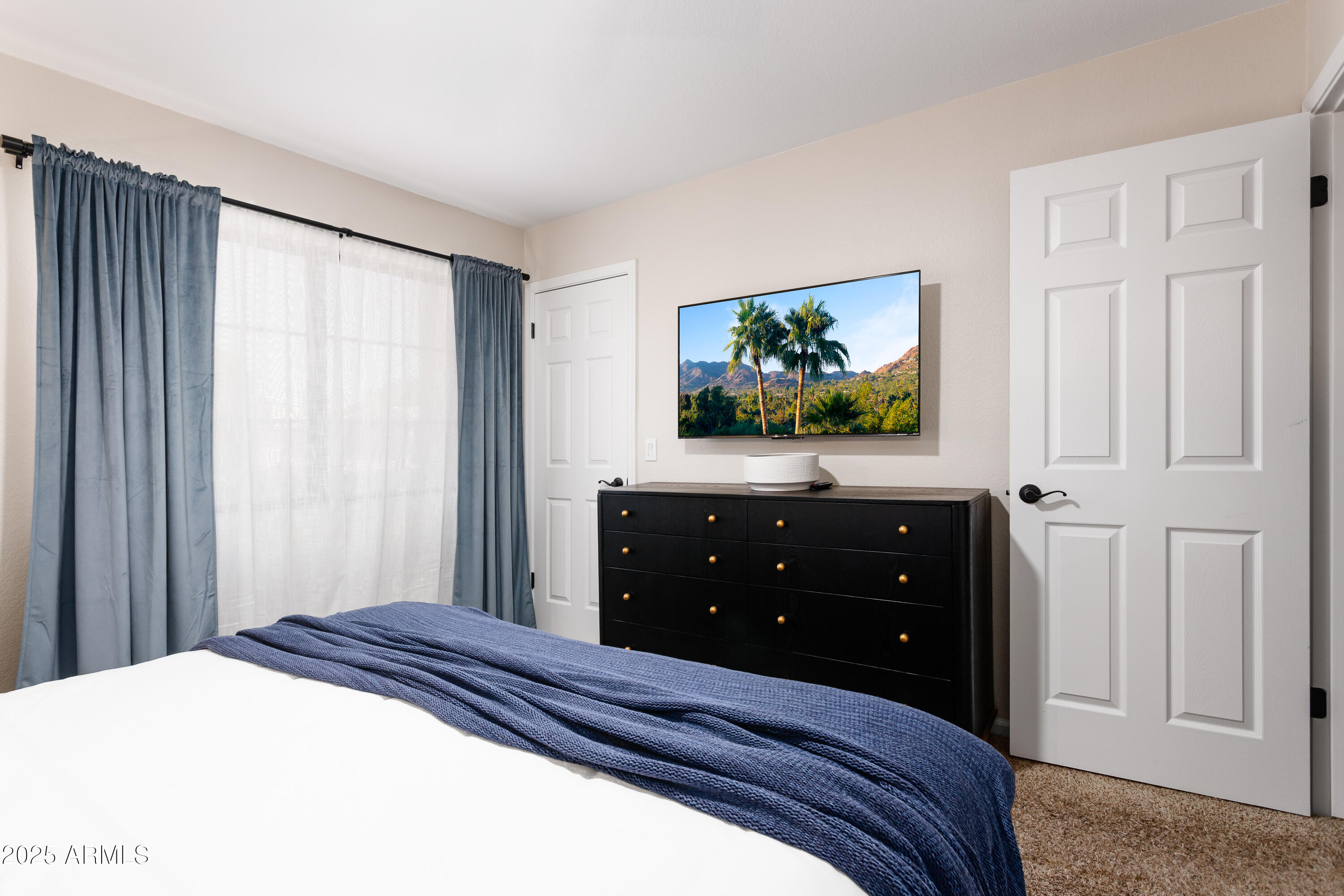 20619 North 16th Way Phoenix, AZ 85024 - Photo 36 of 64 a bedroom with a bed and a flat screen tv