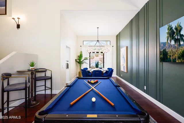a dining room with furniture potted plants and wooden floor