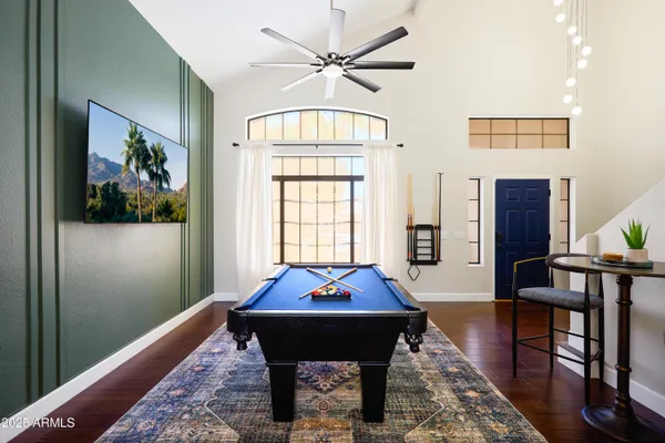 a living room with furniture a table and a large window