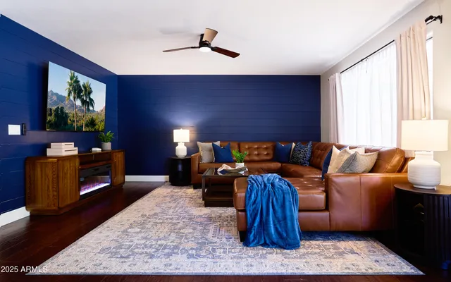 a kitchen with stainless steel appliances kitchen island granite countertop a stove top oven a sink dishwasher a dining table and chairs with wooden floor