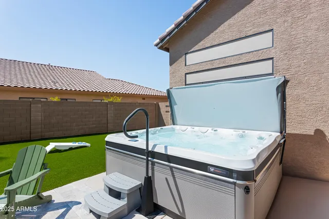 a swimming pool with outdoor seating and yard
