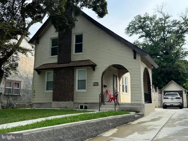 a front view of a house with a garden and garage