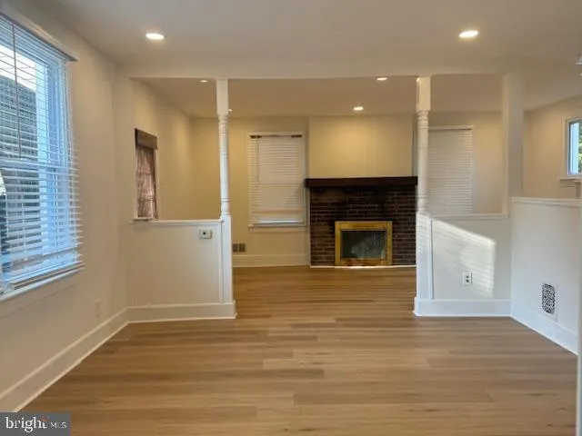 a view of a hall with wooden floor