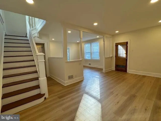 a view of a room with wooden floor and fireplace