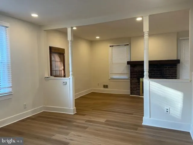 a view of a hallway with wooden floor