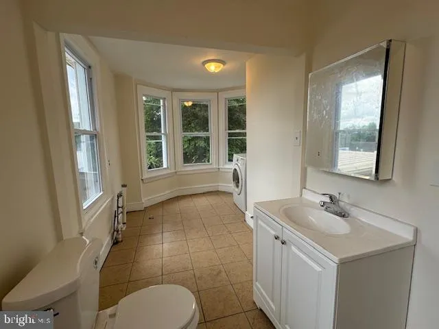 a bathroom with a sink mirror and a bathtub