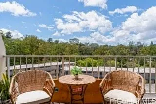 a balcony with table and chairs