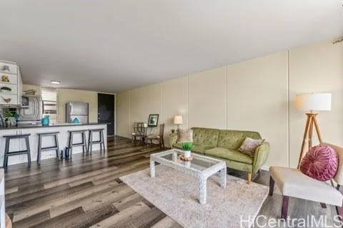 a living room with furniture a rug and a table