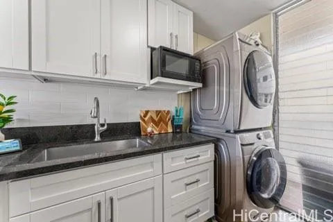 a close view of a sink and washer in a kitchen