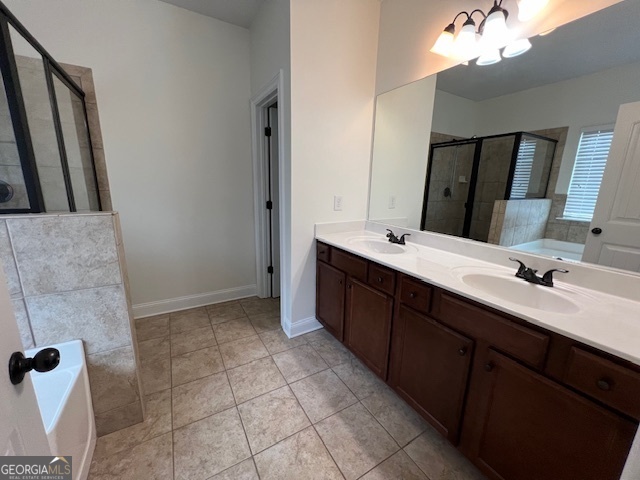 5375 Rialto Way Cumming, GA 30040 - Photo 36 of 42 a bathroom with a double vanity sink a mirror and a bathtub