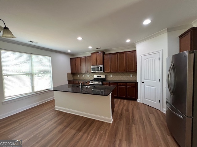 5375 Rialto Way Cumming, GA 30040 - Photo 5 of 42 a kitchen with granite countertop wooden floors stainless steel appliances and window