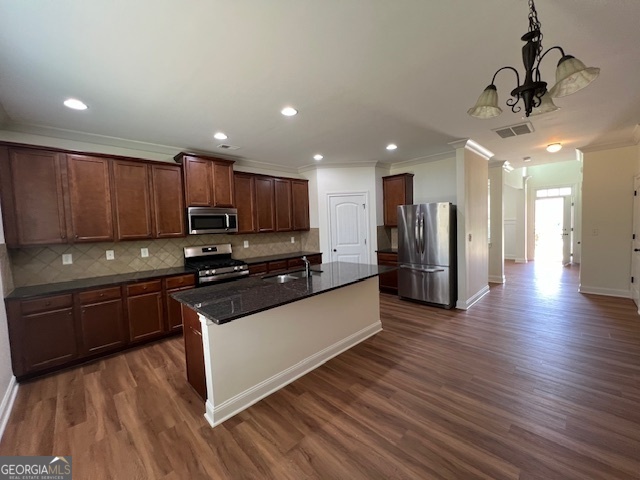 5375 Rialto Way Cumming, GA 30040 - Photo 6 of 42 a kitchen with stainless steel appliances granite countertop a refrigerator a sink dishwasher a stove and a microwave oven on the wooden floor