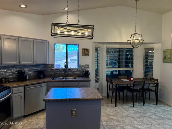 a kitchen with a counter space a sink stainless steel appliances and cabinets