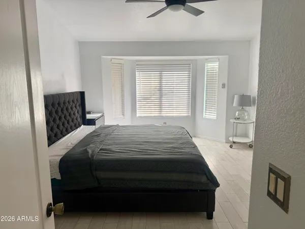 a bedroom with a bed and window