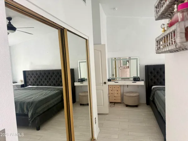 a bathroom with a granite countertop sink and a washing machine