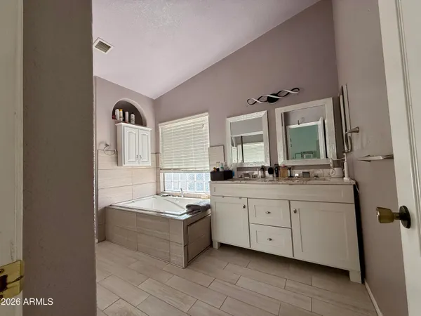 a bathroom with sink bathtub and window