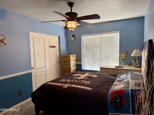 a bedroom with a bed and a chandelier