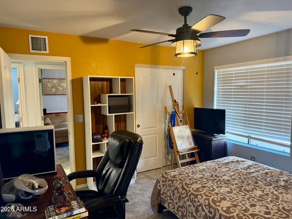 a bedroom with a workspace