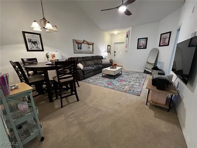a living room with furniture a piano and a flat screen tv