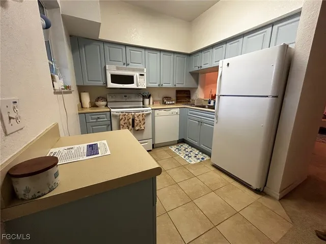 a kitchen with a refrigerator a stove top oven a sink and dishwasher
