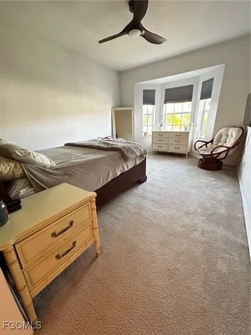 a spacious bedroom with a bed and window