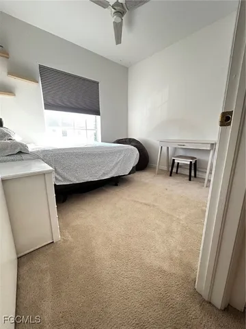 a bedroom with furniture and a ceiling fan