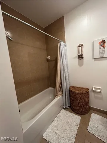 a bathroom with a tub and a shower