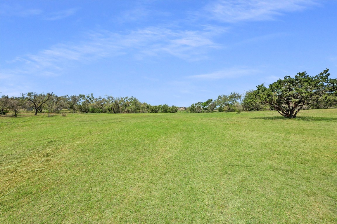 17650 C Hamilton Pool Road Austin, TX 78738 - Photo 6 of 9 a view of a big yard with a house in the background