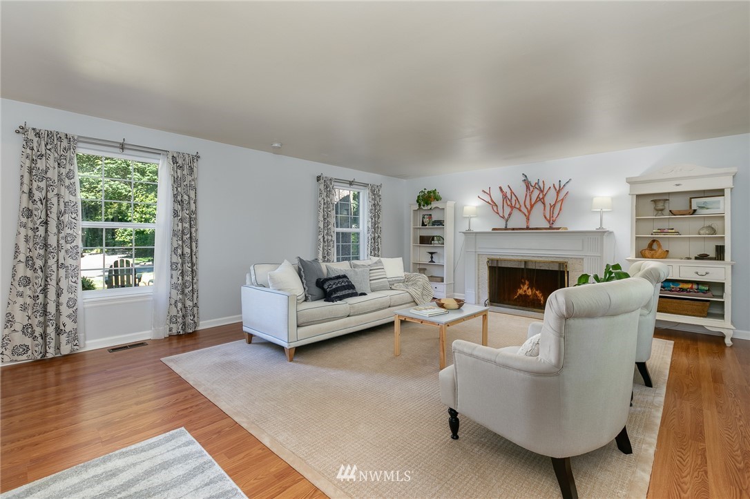 13546 Sherman Road Northwest Seattle, WA 98177 - Photo 4 of 33 a living room with furniture and a fireplace
