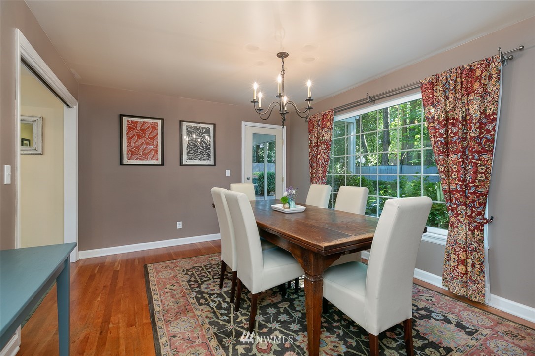 13546 Sherman Road Northwest Seattle, WA 98177 - Photo 7 of 33 a dining room with furniture a rug and a chandelier