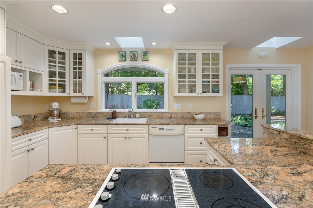 13546 Sherman Road Northwest Seattle, WA 98177 - Photo 9 of 33 a large kitchen with kitchen island a large window in it