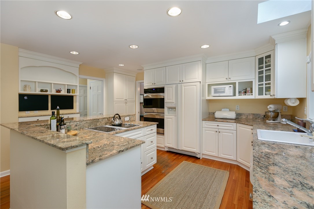 13546 Sherman Road Northwest Seattle, WA 98177 - Photo 10 of 33 a kitchen with sink stove and refrigerator