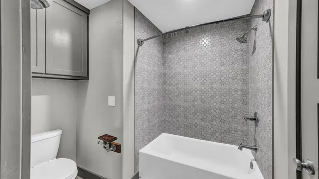 a bathroom with a shower and a toilet