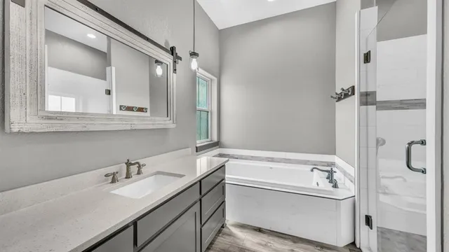 a bathroom with a sink a mirror and a bathtub