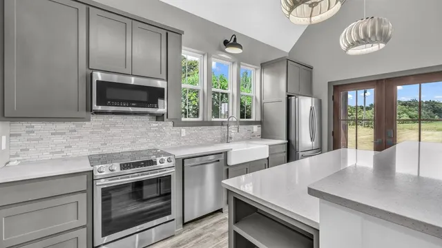 a kitchen with a stove a sink and a microwave