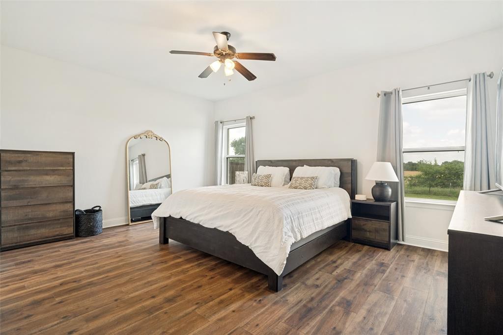 9424 Wildcat Ridge Godley, TX 76044 - Photo 17 of 25 a bedroom with a large bed and a window