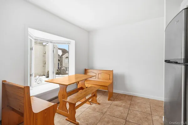 a dining room with furniture and window