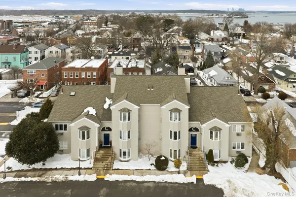 a view of a white house with large windows
