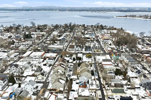 an aerial view of residential building and ocean