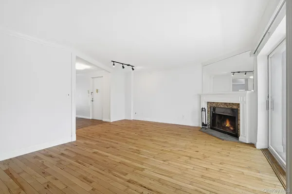 a view of empty room with a fireplace