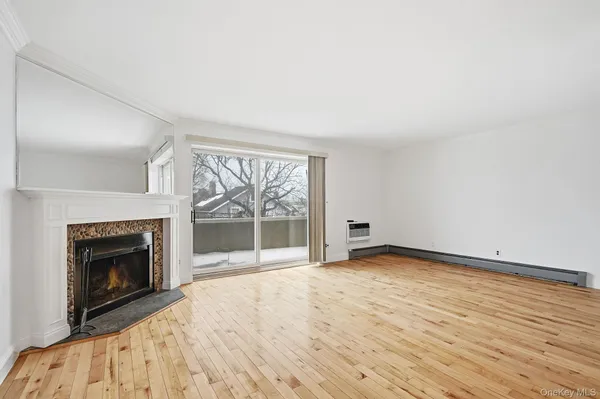 wooden floor fireplace and natural light in room