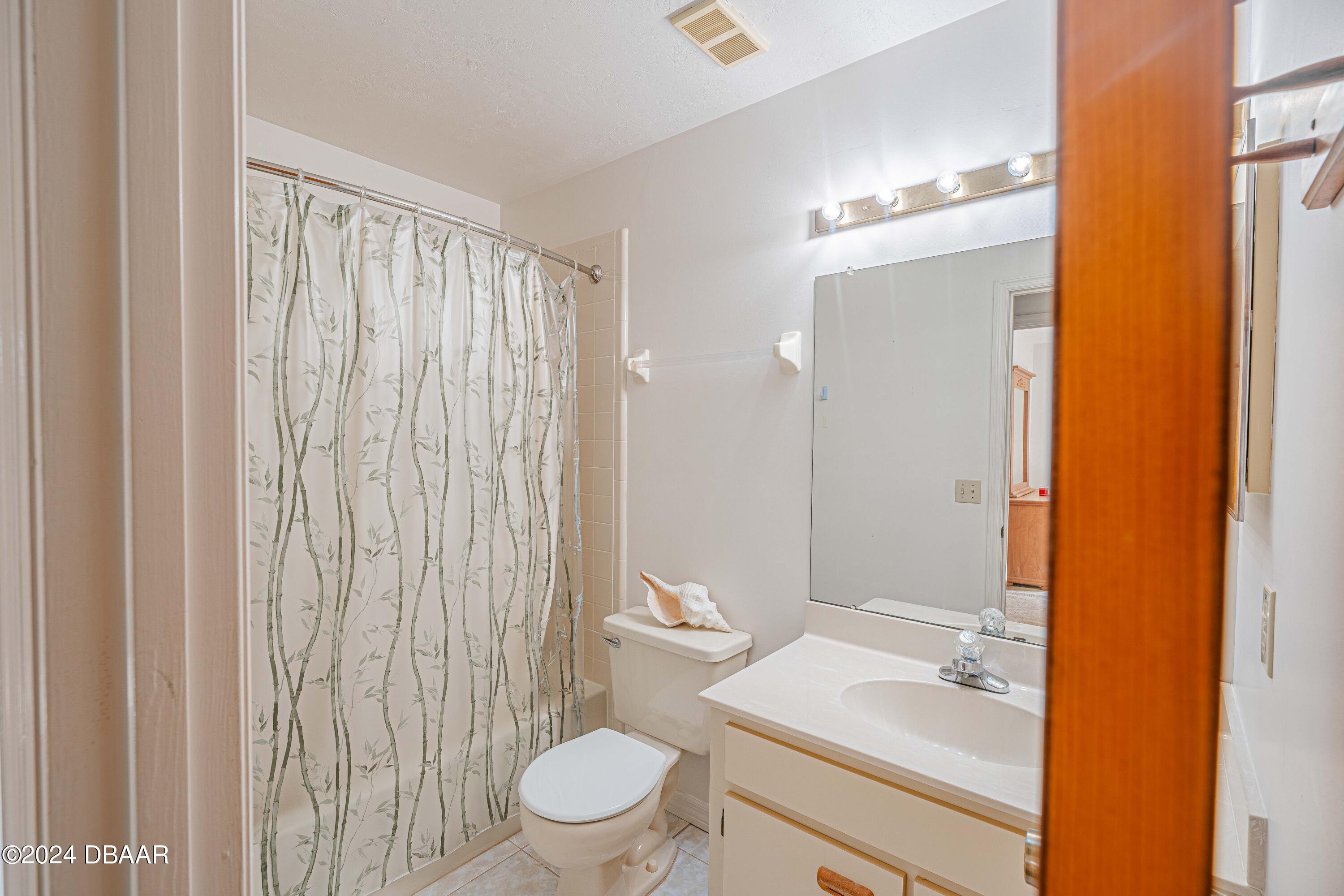 42 Jana Drive Ponce Inlet, FL 32127 - Photo 10 of 34 a bathroom with a granite countertop sink toilet and shower