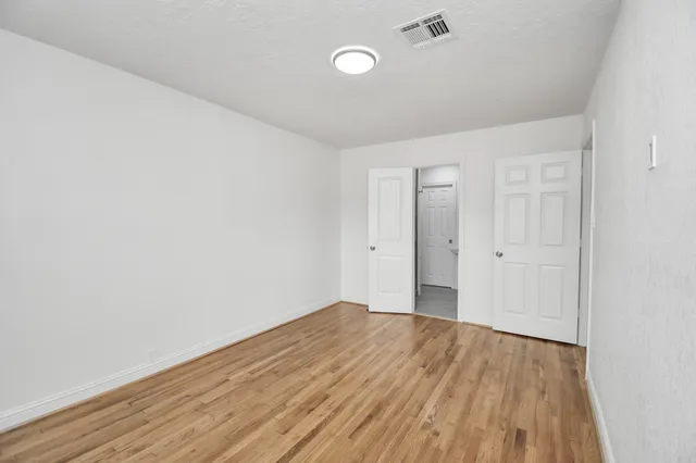 a view of a room with wooden floor