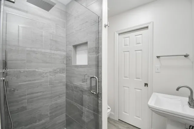 a bathroom with a shower a toilet and sink