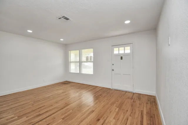 wooden floor in an empty room with a window