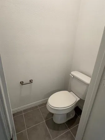 a white toilet sitting next to a white sink