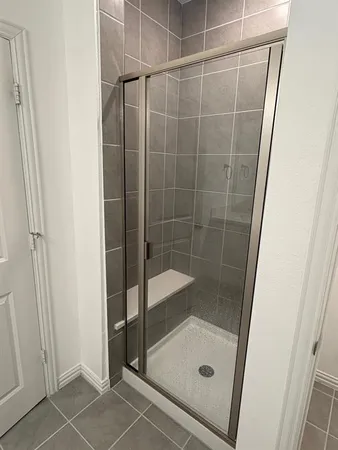 a bathroom with a glass shower door