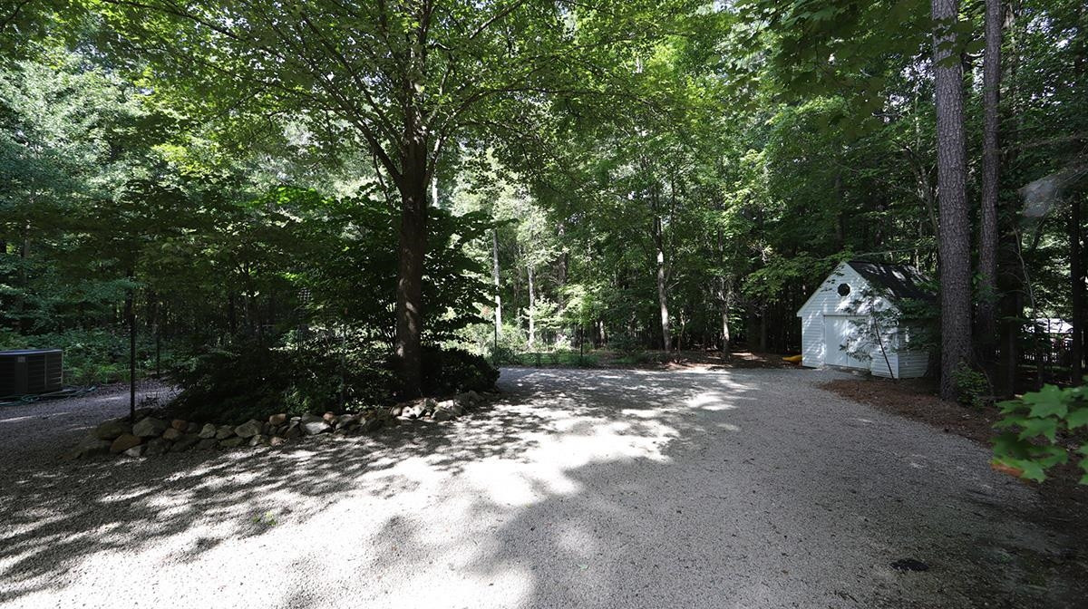2413 Pleasant Union Church Road Raleigh, NC 27614 - Photo 27 of 30 Convenient circular driveway as well as roomy storage shed with shelving. Rear Side Yard