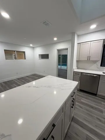 a kitchen with a stove a sink and a refrigerator
