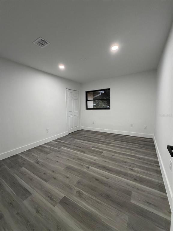 731 Bongart Road Winter Park, FL 32792 - Photo 13 of 28 an empty room with wooden floor and windows